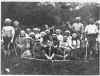 Grupo de personas Ymana de Tierra del Fuego usando pintura facial y corporal para la ceremonia de iniciacin chijaus. El segundo individuo desde la izquierda sentado en la ltima fila es M. Gusinde. Foto tomada por M. Gusinde (o colaboradores) en 1922.
